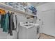 Well-organized laundry room with washer, dryer, storage shelves, and hanging space at 4809 W Erie St, Chandler, AZ 85226