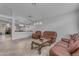 Spacious living room with tile floors, neutral walls, and classic leather furniture, perfect for relaxation and entertaining at 4809 W Erie St, Chandler, AZ 85226