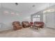 Bright living room with tile floors, neutral walls, and classic leather furniture, offering a welcoming atmosphere at 4809 W Erie St, Chandler, AZ 85226