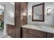 Double sink vanity in the ensuite bath with granite counters, wood cabinetry and walk-in shower views at 4809 W Erie St, Chandler, AZ 85226