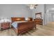 Spacious main bedroom featuring wood floors, dresser, ceiling fan and light-colored walls at 4809 W Erie St, Chandler, AZ 85226