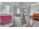The renovated walk-in shower is fitted with glass surround, gray-tiled walls, and a river rock base at 4809 W Erie St, Chandler, AZ 85226