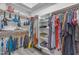 Spacious walk-in closet with custom shelving, hanging rods and bright lighting at 4809 W Erie St, Chandler, AZ 85226