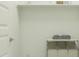 Functional laundry room with shelving, storage space, and neutral tones for a clean aesthetic at 5043 S 233Rd Dr, Buckeye, AZ 85326