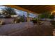 Covered patio boasts brick pavers, desert landscaping, ambient lighting, and backyard access at 5206 S Clark Dr, Tempe, AZ 85283