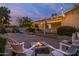 Backyard patio featuring a cozy fire pit with seating and string lights at 5206 S Clark Dr, Tempe, AZ 85283