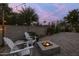 Backyard patio at dusk featuring a cozy fire pit and string lights at 5206 S Clark Dr, Tempe, AZ 85283
