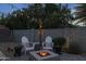 Cozy backyard patio with string lights, fire pit, and comfortable seating at 5206 S Clark Dr, Tempe, AZ 85283