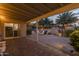 Covered patio overlooking backyard with patio, fire pit, and string lights at 5206 S Clark Dr, Tempe, AZ 85283