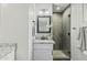 Bathroom with a walk-in shower, granite countertop, black fixtures and modern vanity lights at 5206 S Clark Dr, Tempe, AZ 85283