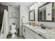 Well-lit bathroom features a double sink vanity with granite countertop and a decorative mirror at 5206 S Clark Dr, Tempe, AZ 85283