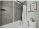Bathroom featuring tiled shower, stylish shower curtain, a decorative shelf and toilet at 5206 S Clark Dr, Tempe, AZ 85283
