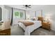 Bright bedroom features a ceiling fan, large window and a chunky knit blanket for a cozy feel at 5206 S Clark Dr, Tempe, AZ 85283