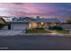 Inviting home showcasing lush green lawn, mature landscaping, and decorative window accents at 5206 S Clark Dr, Tempe, AZ 85283