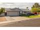 Lovely home featuring a large driveway, tidy landscaping, and a well-maintained lawn at 5206 S Clark Dr, Tempe, AZ 85283