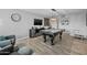 Stylish game room with a sleek pool table, modern light fixture, and contemporary decor at 5206 S Clark Dr, Tempe, AZ 85283