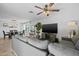 Comfortable living room features a large TV, gray sectional, dining area and a ceiling fan at 5206 S Clark Dr, Tempe, AZ 85283