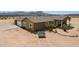 Spacious desert property featuring an expansive lot, a detached garage and a charming single-story home at 54463 W Sunburst St, Maricopa, AZ 85139