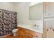 Bathroom featuring wood cabinets, a shower and a shower curtain at 54463 W Sunburst St, Maricopa, AZ 85139