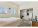 Bright bedroom featuring two windows, a bed and a closet with sliding doors at 54463 W Sunburst St, Maricopa, AZ 85139