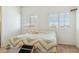 Bedroom featuring carpet, two windows and a chevron patterned bedspread at 54463 W Sunburst St, Maricopa, AZ 85139