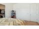 Bedroom featuring carpet, and neutral colored walls with an adjacent closet at 54463 W Sunburst St, Maricopa, AZ 85139