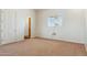 This is a bright bedroom with a tan carpet and a window for lots of natural light at 54463 W Sunburst St, Maricopa, AZ 85139