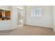 This is a bright bedroom with a tan carpet and a window for lots of natural light at 54463 W Sunburst St, Maricopa, AZ 85139