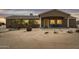 Charming single-story home featuring desert landscaping, a covered porch, and warm exterior lighting at 54463 W Sunburst St, Maricopa, AZ 85139