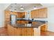 Well-lit kitchen with knotty pine cabinets, a dark granite countertop and stainless steel appliances at 54463 W Sunburst St, Maricopa, AZ 85139
