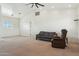 Bright living room with neutral carpet, white walls and comfortable furnishings at 54463 W Sunburst St, Maricopa, AZ 85139