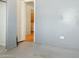 Room with gray painted walls, doorway leading to kitchen and laundry room with machines at 54463 W Sunburst St, Maricopa, AZ 85139