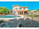 Inviting backyard featuring a sparkling pool, pergola, desert landscaping, and a covered patio perfect for outdoor entertaining at 5513 E Grovers Ave, Scottsdale, AZ 85254