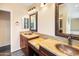 Well-lit bathroom with dual sinks, granite countertops, and bronze fixtures offer functionality and beauty at 5513 E Grovers Ave, Scottsdale, AZ 85254