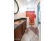 Bathroom featuring a copper sink, decorative mirror, vanity, and tile flooring at 5513 E Grovers Ave, Scottsdale, AZ 85254