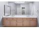 Well-lit bathroom featuring dual sinks and a large mirror, offering functionality and space at 5513 E Grovers Ave, Scottsdale, AZ 85254