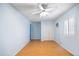 Bright bedroom featuring hardwood floors, a ceiling fan, and a window with white shutters at 5513 E Grovers Ave, Scottsdale, AZ 85254