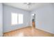Bright bedroom with hardwood floors, large windows with plantation shutters, and ample space for rest and relaxation at 5513 E Grovers Ave, Scottsdale, AZ 85254