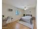 Neat bedroom featuring wood floors, shuttered window, and ceiling fan at 5513 E Grovers Ave, Scottsdale, AZ 85254