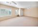 Large bedroom with neutral carpet, ceiling fans, and shuttered windows for bright, natural light at 5513 E Grovers Ave, Scottsdale, AZ 85254