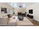 Well-lit living room with fireplace, comfortable seating, modern decor, and stylish accents at 5513 E Grovers Ave, Scottsdale, AZ 85254