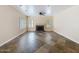 Spacious living room with patterned tile floors, ceiling fan, neutral color palette, and shuttered windows at 5513 E Grovers Ave, Scottsdale, AZ 85254