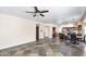 Open-concept living room connecting the dining area and kitchen, with tile floors and ample natural light at 5513 E Grovers Ave, Scottsdale, AZ 85254