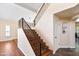 Staircase with wood steps and black railings, and light-colored walls and wood floors at 5513 E Grovers Ave, Scottsdale, AZ 85254