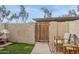 Enclosed backyard with artificial grass, a gate, and outdoor seating at 5808 E Brown Rd # 140, Mesa, AZ 85205