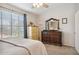 Bright bedroom with large window, dresser, and neutral carpet at 5808 E Brown Rd # 140, Mesa, AZ 85205