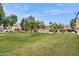 Expansive lawn area with trees and community buildings at 5808 E Brown Rd # 140, Mesa, AZ 85205