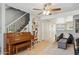 Open-concept living space with tile floors, a ceiling fan, and a staircase at 5808 E Brown Rd # 140, Mesa, AZ 85205