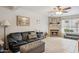 Comfortable living room with a fireplace, tile floors, and a large leather couch at 5808 E Brown Rd # 140, Mesa, AZ 85205