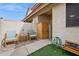 Private patio with seating, storage, and a well-manicured artificial grass area at 5808 E Brown Rd # 140, Mesa, AZ 85205